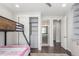 Cozy bedroom featuring a stylish bunk bed, ceiling fan and direct access to the bathroom at 15843 E Broncos Pl, Englewood, CO 80112