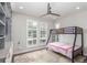 Comfortable bedroom featuring a stylish bunk bed, ceiling fan and shuttered windows at 15843 E Broncos Pl, Englewood, CO 80112