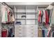 Organized walk-in closet with shelving, drawers, and hanging space for ample storage at 15843 E Broncos Pl, Englewood, CO 80112
