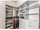 Spacious walk-in closet with custom shelving and drawers for optimal organization and storage at 15843 E Broncos Pl, Englewood, CO 80112