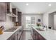 Bright kitchen featuring quartz countertops, stainless appliances, and a gas range at 15843 E Broncos Pl, Englewood, CO 80112