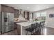 Spacious kitchen with quartz countertops, stainless appliances, and island seating at 15843 E Broncos Pl, Englewood, CO 80112