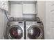Modern laundry room featuring front-load washer and dryer with built in shelving at 15843 E Broncos Pl, Englewood, CO 80112