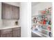 Walk-in pantry offers ample shelving and cabinet storage space at 15843 E Broncos Pl, Englewood, CO 80112