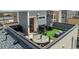 Aerial view of the rooftop patio with dining and lounging, perfect for entertaining at 15843 E Broncos Pl, Englewood, CO 80112