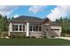 Charming single-story home with stone accents, covered porch, and well-maintained landscaping at 2610 Bitterroot Pl, Highlands Ranch, CO 80129