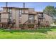 Townhome backyard showcasing lawn, decks, and exterior staircase for a private entrance at 4202 Greenbriar Blvd # 46, Boulder, CO 80305