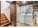 This basement has a laundry area with washer and dryer hookups and wooden stairs at 4202 Greenbriar Blvd # 46, Boulder, CO 80305