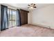 This bedroom has a sliding glass door to a patio, ceiling fan, and ample closet space at 4202 Greenbriar Blvd # 46, Boulder, CO 80305