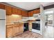 This is a cozy kitchen with wood cabinets, laminate countertops, and tile backsplash at 4202 Greenbriar Blvd # 46, Boulder, CO 80305