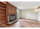 Cozy living room shows a brick fireplace, hardwood floors, and large windows, blending classic and modern styles at 4202 Greenbriar Blvd # 46, Boulder, CO 80305