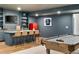 Basement bar with island seating, pool table, and stylish decor for entertaining and relaxation at 5693 Missoula Trl, Castle Rock, CO 80108