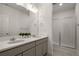 A bright bathroom features a double vanity with elegant quartz countertops and a glass-enclosed walk-in shower at 5693 Missoula Trl, Castle Rock, CO 80108