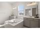 Bright bathroom with a soaking tub, double sinks and large window at 5693 Missoula Trl, Castle Rock, CO 80108
