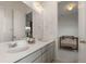 Well-appointed bathroom featuring double sinks, quartz countertops and modern lighting at 5693 Missoula Trl, Castle Rock, CO 80108