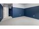 An empty bedroom showing a two-tone color scheme of blue and white on the walls and plush light-colored carpet at 5693 Missoula Trl, Castle Rock, CO 80108