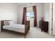 Bright bedroom with a wooden bed frame, carpet flooring and pink accents at 5693 Missoula Trl, Castle Rock, CO 80108