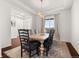 Dining room with wood floors, chandelier, six chairs, and a large window at 5693 Missoula Trl, Castle Rock, CO 80108