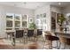 Bright dining room area features a large table near the modern open kitchen design at 5693 Missoula Trl, Castle Rock, CO 80108