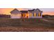 Charming single-Gathering home featuring a two-car garage and inviting front porch at dusk at 5693 Missoula Trl, Castle Rock, CO 80108