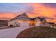 Wide shot of a single-Gathering home featuring a two-car garage and a paved driveway at 5693 Missoula Trl, Castle Rock, CO 80108