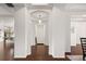 Open hallway with hardwood floors and architectural columns at 5693 Missoula Trl, Castle Rock, CO 80108