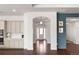 Hallway with hardwood floors with architectural columns and white trim at 5693 Missoula Trl, Castle Rock, CO 80108