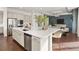 Contemporary kitchen featuring stainless steel appliances, a large island with seating, and a seamless connection to the living space at 5693 Missoula Trl, Castle Rock, CO 80108