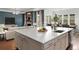 Spacious open concept with a large kitchen island overlooking a cozy living room and dining area at 5693 Missoula Trl, Castle Rock, CO 80108