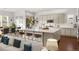 Open-concept kitchen with a large island, bar stools, and modern appliances flowing seamlessly into the dining and living areas at 5693 Missoula Trl, Castle Rock, CO 80108