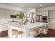 Bright kitchen features a large center island with seating, stainless steel appliances, and ample counter space at 5693 Missoula Trl, Castle Rock, CO 80108