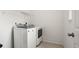 A well-equipped laundry room offers convenience with modern appliances and overhead shelving at 5693 Missoula Trl, Castle Rock, CO 80108