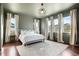 Spacious main bedroom featuring hardwood floors, multiple windows and a modern ceiling fan at 5693 Missoula Trl, Castle Rock, CO 80108
