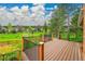Inviting back deck with black metal railings overlooks a lush green space at 7583 S Xanthia Ct, Centennial, CO 80112