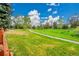 Green space with a walking path, lush lawn and mature trees in the neighborhood at 7583 S Xanthia Ct, Centennial, CO 80112