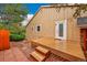 Home exterior showcasing a wood deck and backyard with mature trees at 7583 S Xanthia Ct, Centennial, CO 80112