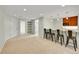 Finished basement with kitchenette, bar seating, and ample storage space at 7583 S Xanthia Ct, Centennial, CO 80112