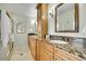 Bathroom featuring dual sinks, marble countertops, and a separate shower for a luxurious experience at 7583 S Xanthia Ct, Centennial, CO 80112