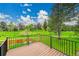 Deck featuring wood flooring and black metal railings, overlooking a grassy green space at 7583 S Xanthia Ct, Centennial, CO 80112