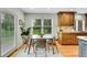 Dining room with large windows and a modern table, complemented by natural light and a serene view at 7583 S Xanthia Ct, Centennial, CO 80112