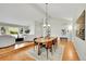 Open-concept dining area with hardwood floors, stylish furniture, and seamless flow to the living area at 7583 S Xanthia Ct, Centennial, CO 80112