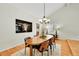 Spacious dining room featuring a large wooden table, modern lighting, and hardwood floors at 7583 S Xanthia Ct, Centennial, CO 80112