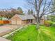Charming brick home with a two-car garage, mature trees, and landscaped yard at 7583 S Xanthia Ct, Centennial, CO 80112