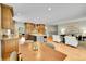 Open-concept kitchen with wood cabinets and granite countertops seamlessly transitions to the inviting living room at 7583 S Xanthia Ct, Centennial, CO 80112