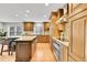 Gourmet kitchen features custom cabinets, granite countertops, a center island, and stainless steel appliances at 7583 S Xanthia Ct, Centennial, CO 80112