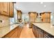 Spacious kitchen featuring stainless steel appliances, granite countertops, and wood cabinetry at 7583 S Xanthia Ct, Centennial, CO 80112