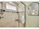 Updated shower featuring a glass enclosure, built in seat, and mosaic tile accents at 7583 S Xanthia Ct, Centennial, CO 80112