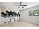 Bedroom featuring a modern accent wall, ceiling fan, and a window providing natural light at 1707 Ostia Cir # 46, Lafayette, CO 80026