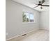 Light filled bedroom with ceiling fan, light gray walls, and wood-look flooring at 1707 Ostia Cir # 46, Lafayette, CO 80026