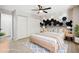 Stylish bedroom featuring a modern accent wall, ceiling fan and natural light at 1707 Ostia Cir # 46, Lafayette, CO 80026